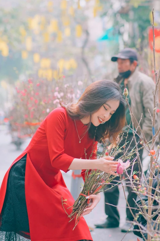 a woman is arranging plants in her garden