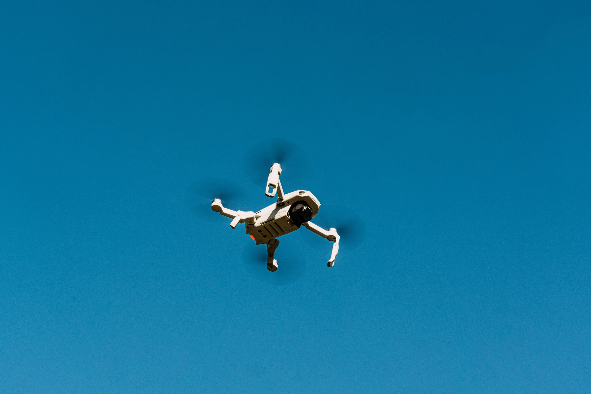 the kite is being flown above a man on a bike