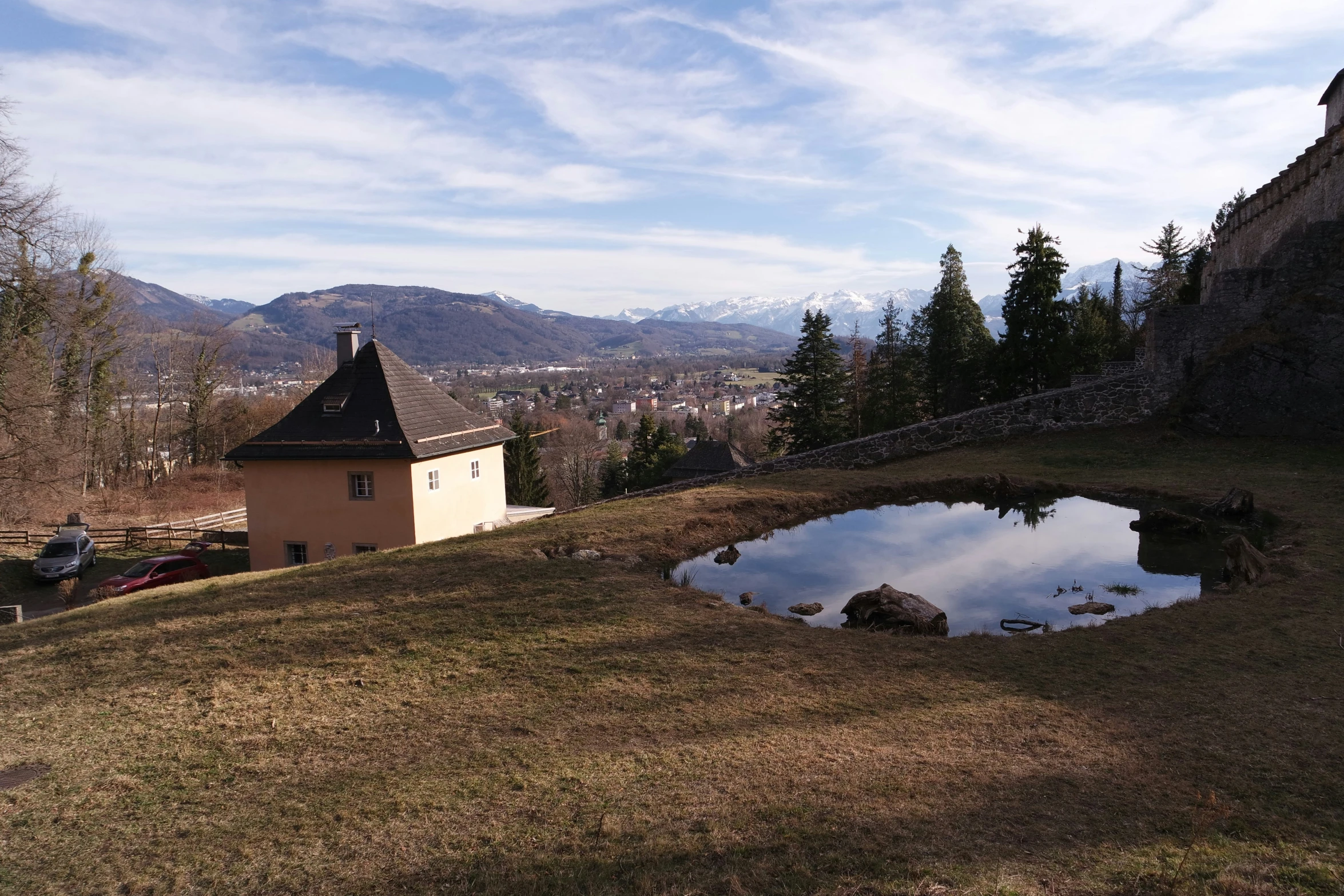 a castle on a hill with a small reflection in the water