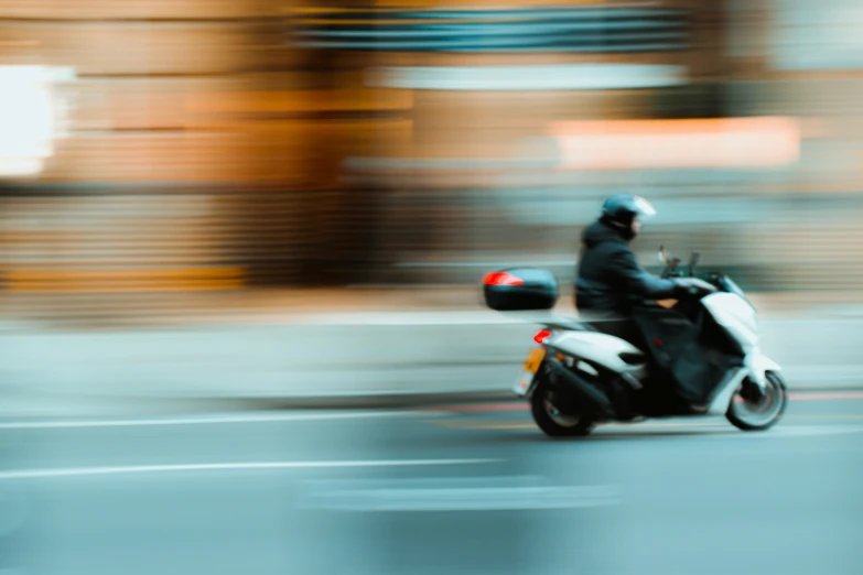 the man is riding his motorcycle in the rain