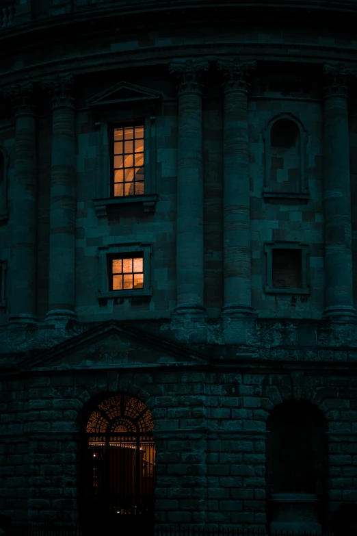 a building at night with many windows and doors