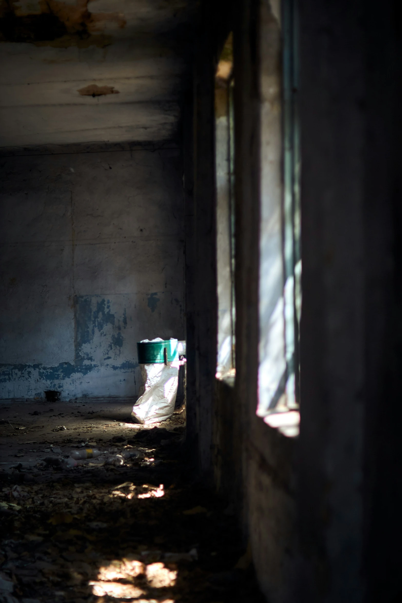 a toilet in a room with shadows and light