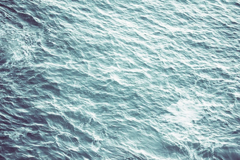 an overhead view of some water and a boat
