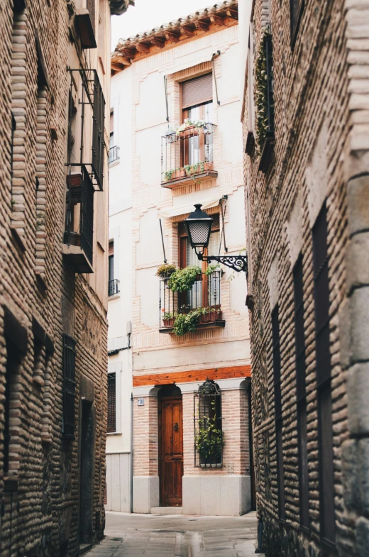 an alley way in a small town, with a brick building