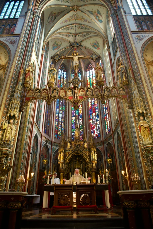 the priest is in his chair at the alter