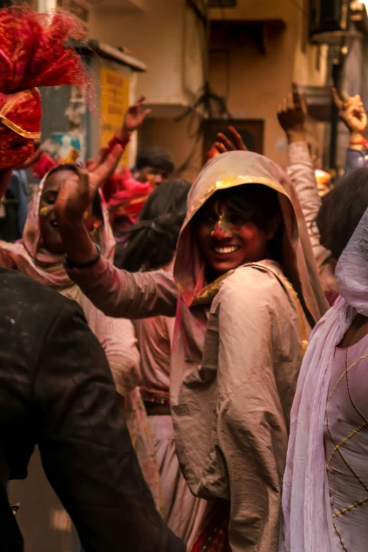 the group of people dressed in indian clothing are smiling