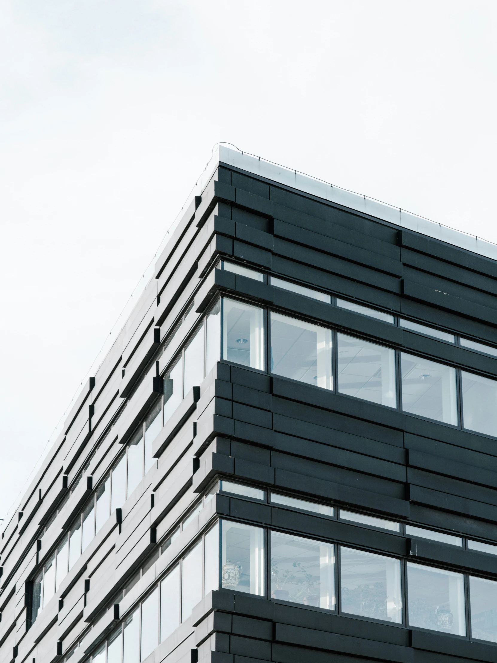 a very tall building that is black with some windows