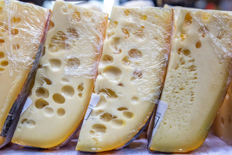 four different kinds of cheese cut in half