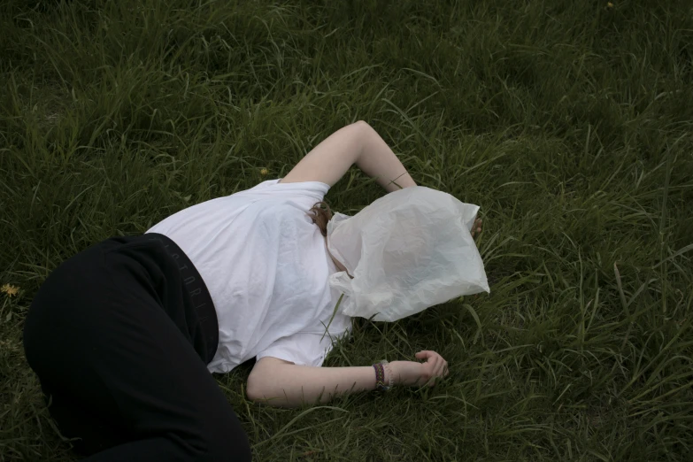 a person that is lying down in the grass
