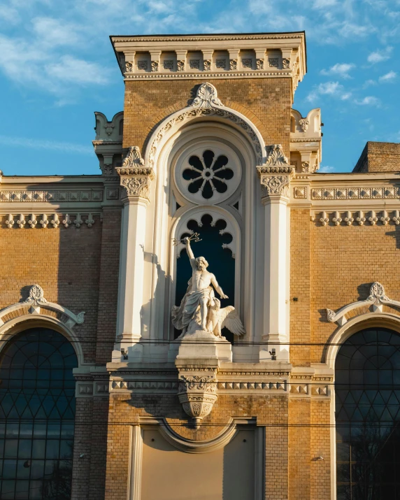 the large building has a statue on the front