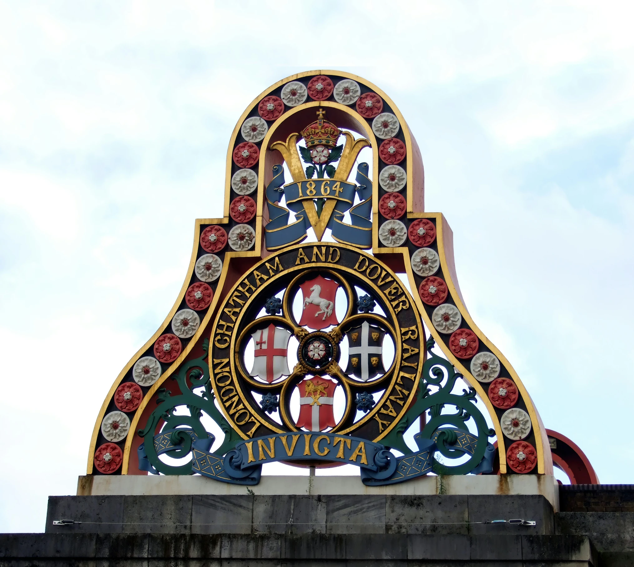 an ornamental iron gate on top of a building