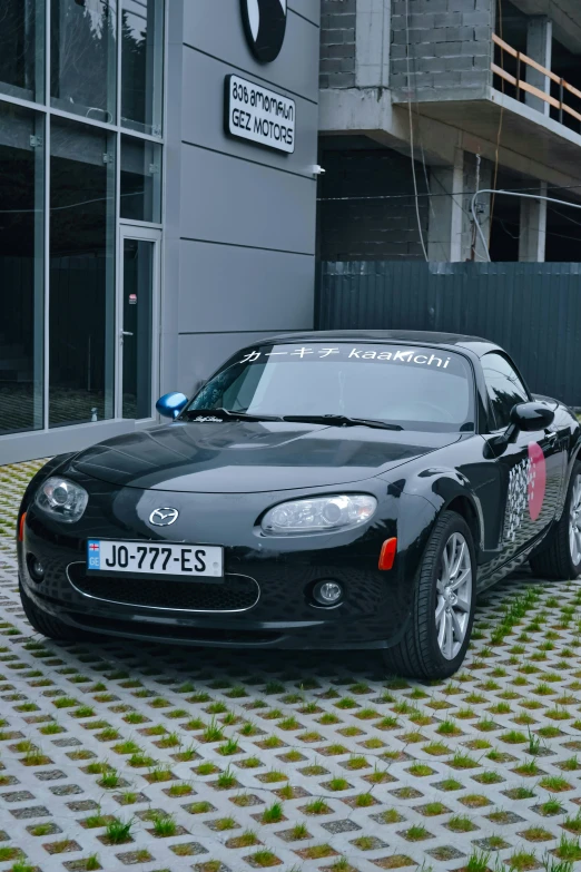 a mazda sports car with the numbers j77 755 - s printed on it