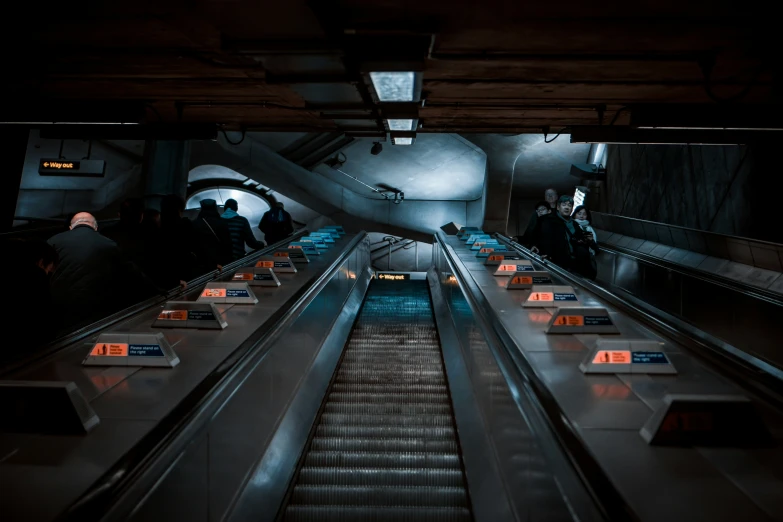 an escalator with people walking up or down it