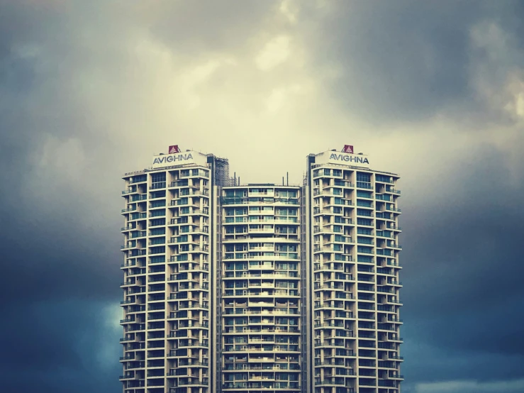 there are two tall building on a cloudy day