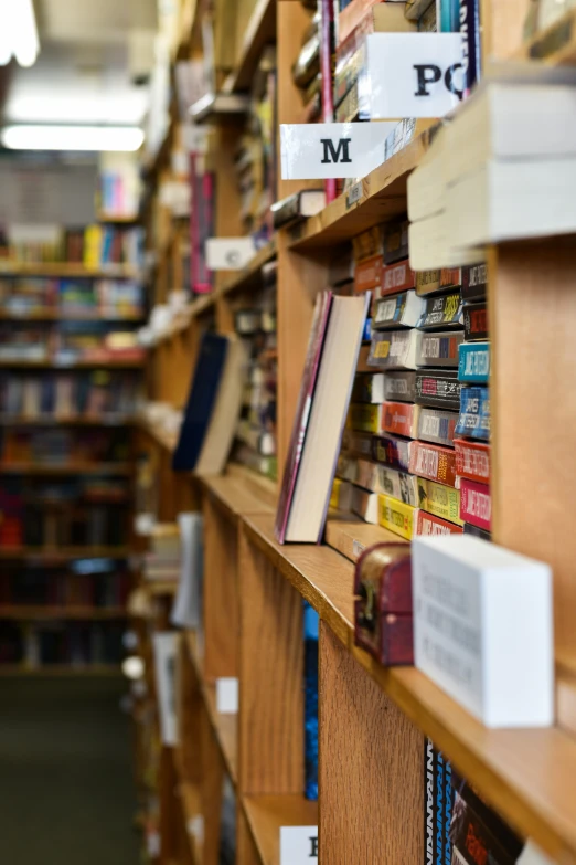 a number of books on shelves near one another