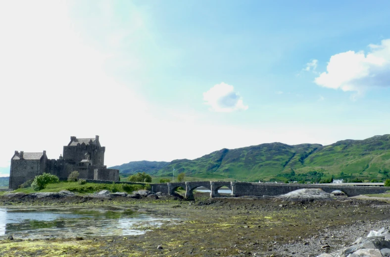 an old castle sits on a rocky island