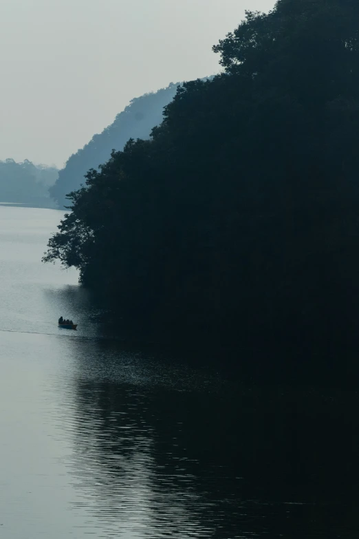 a group of people paddling in small boats on the water