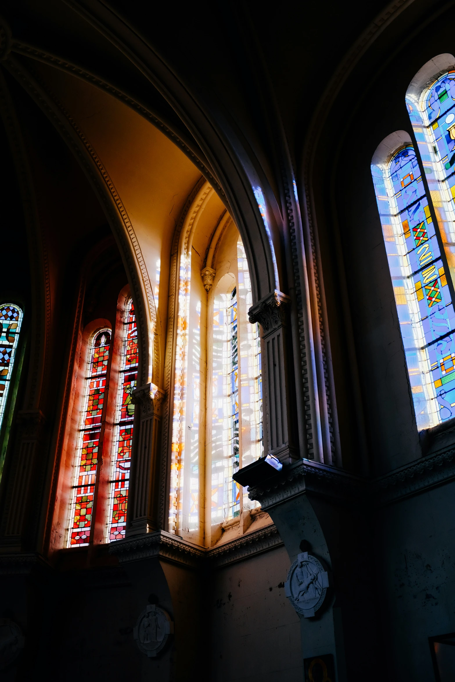 multiple stained glass windows in a large building