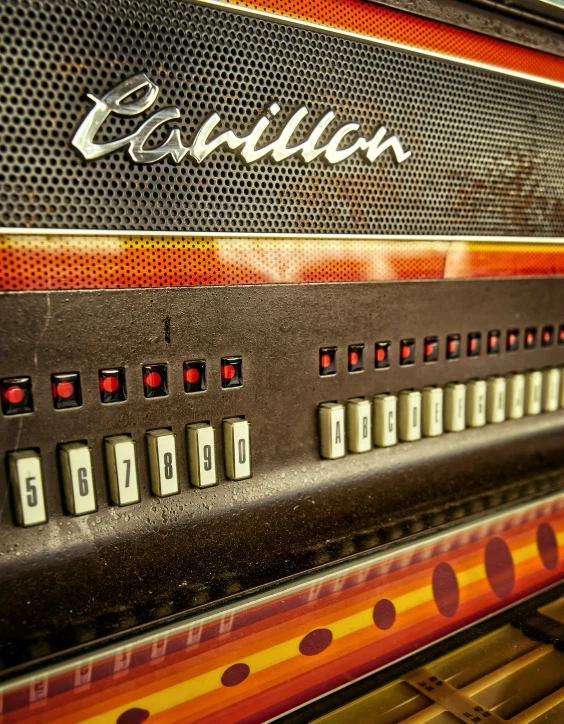 an orange and black striped radio sitting on top of a shelf