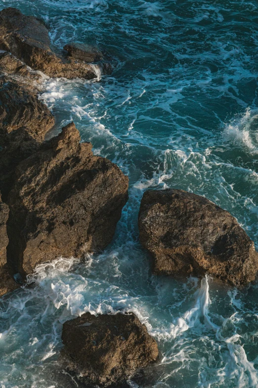 a large body of water next to rocky shore