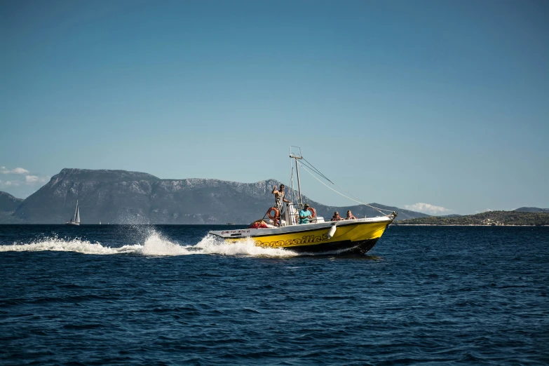 a small yellow boat on a large body of water