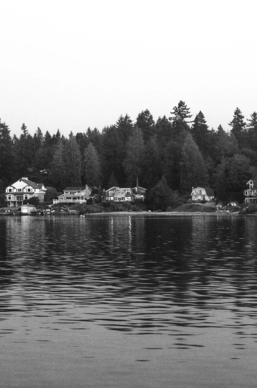 a body of water with houses in the background