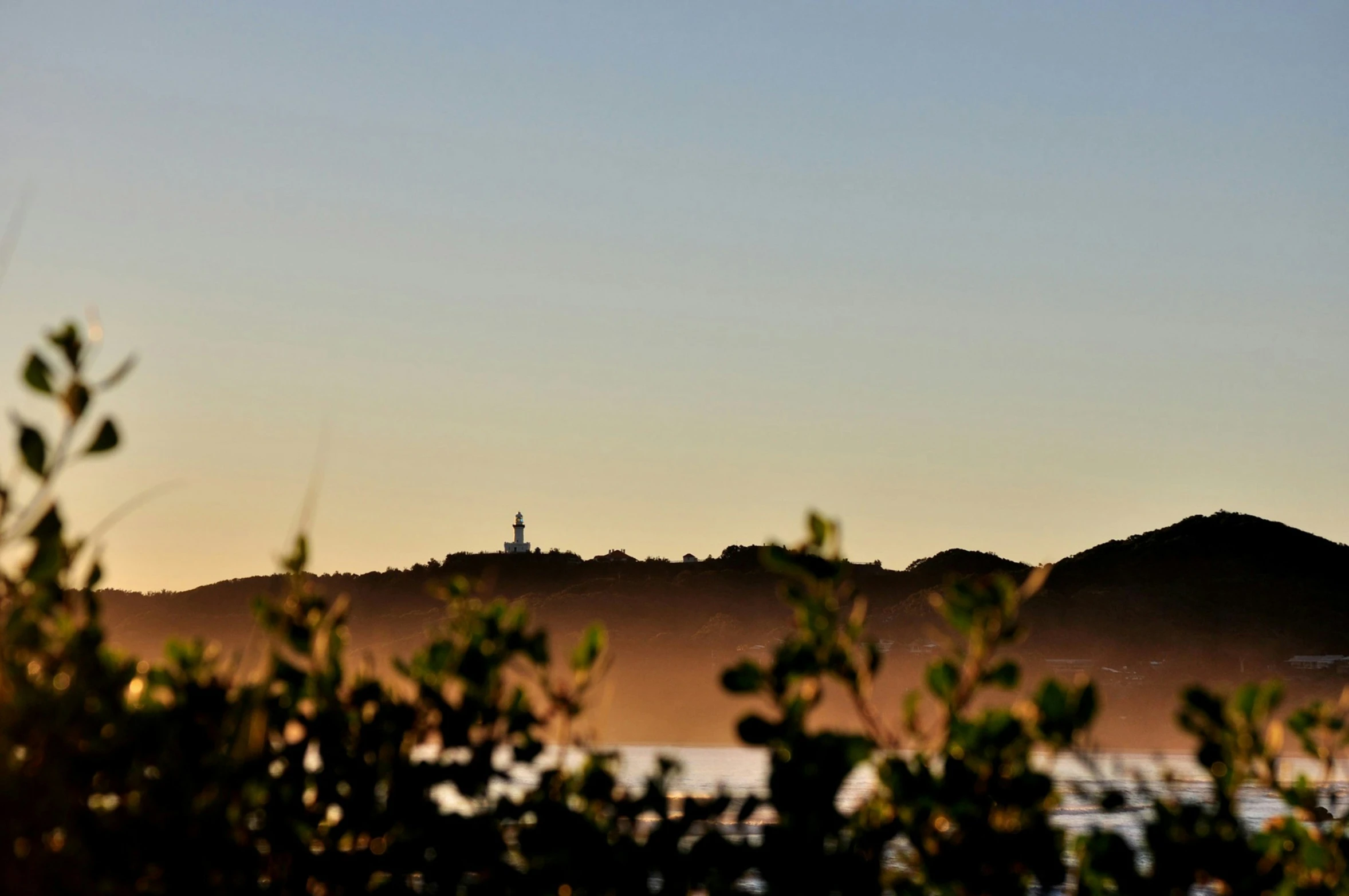 a view of the mountains in silhouette, with trees to the side