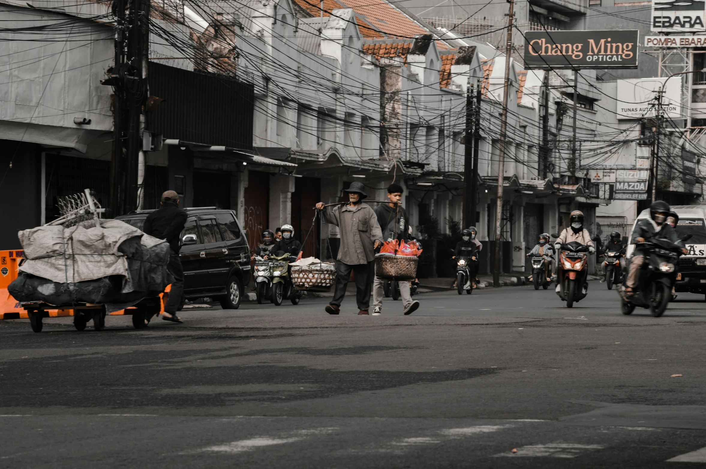 motorcyclists riding on the street with lots of traffic