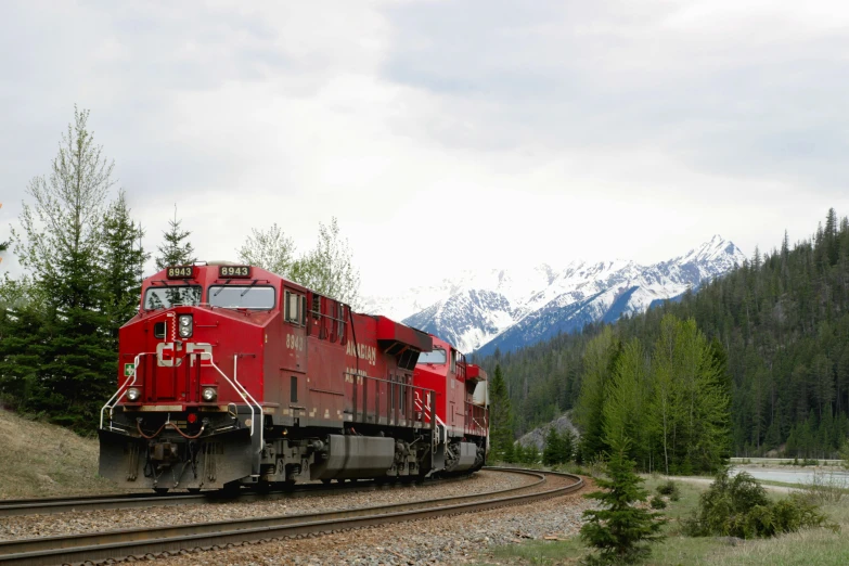 a red train that is traveling down the train tracks