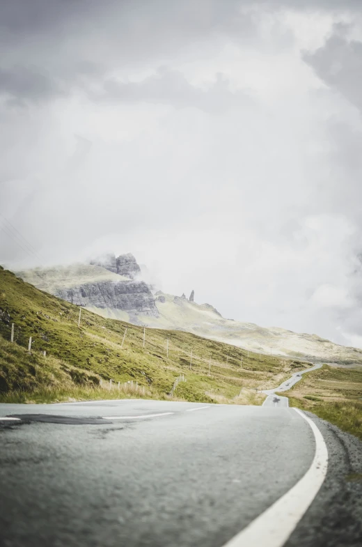 a car is traveling down a narrow, winding road