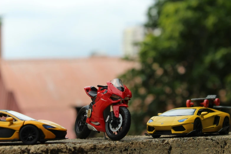 two toy motorcycles are sitting beside each other