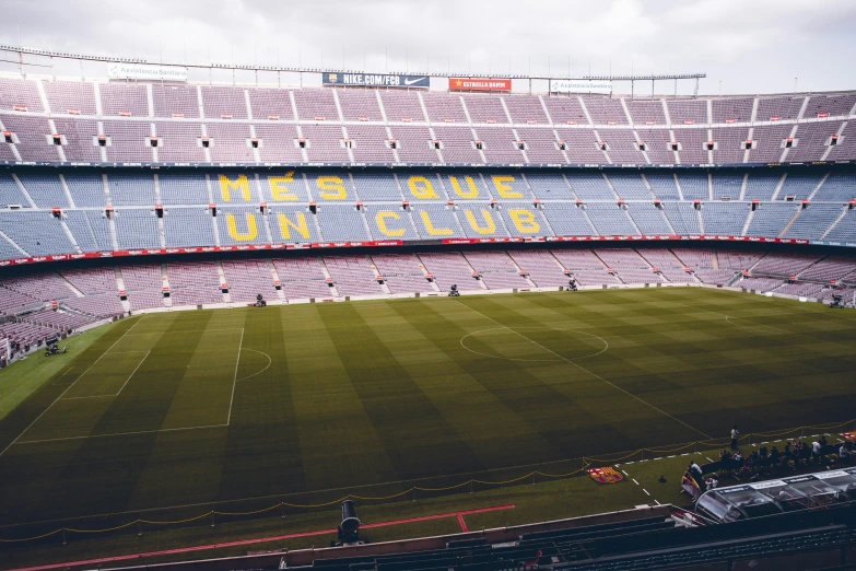 an empty soccer stadium with the field covered in yellow tape