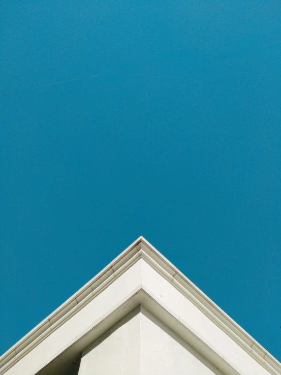 a white building that has a blue sky behind it