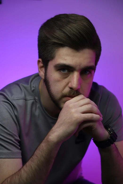 a young man with beard and glasses is holding a pipe