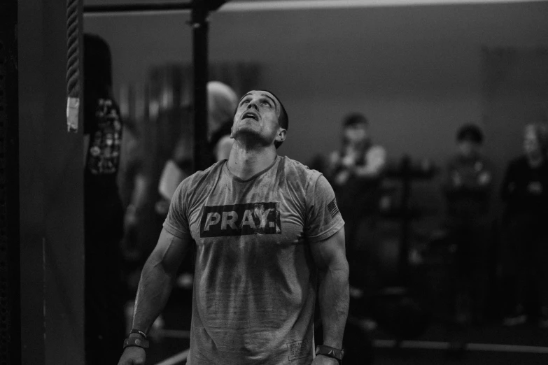 man looking up during gym with crowd in background