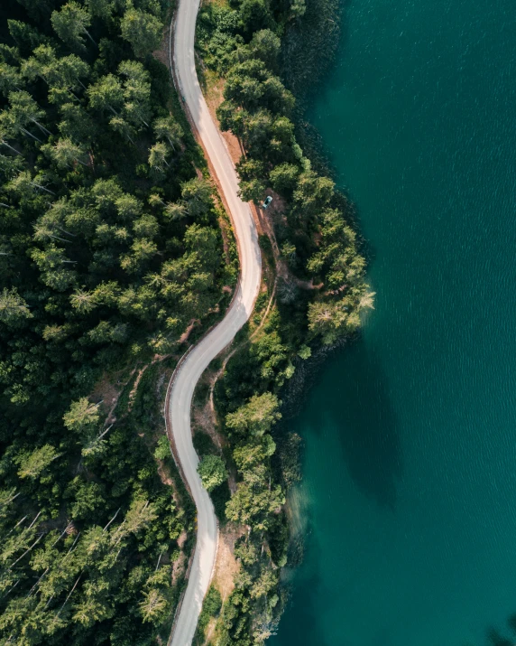 an aerial s of a winding road on a lake