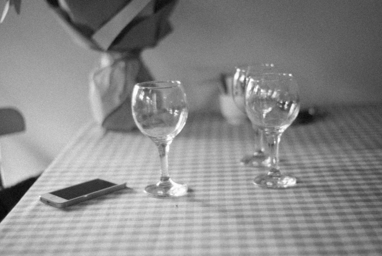 some empty glasses on a table with an ipod nearby