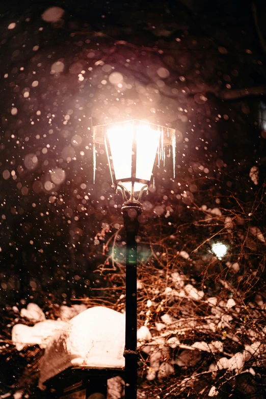 an image of snow on the ground and street light