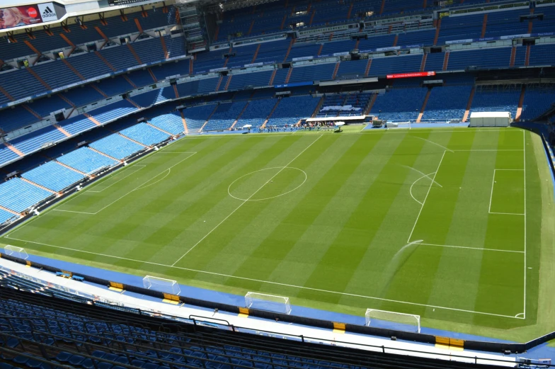 a field at an outdoor stadium with blue chairs