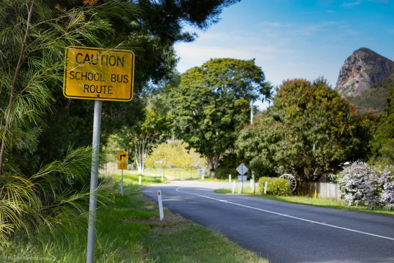 a yellow caution sign on the side of the road