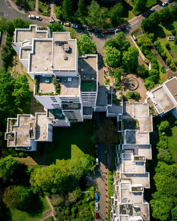 an aerial view of an estate from above, with a driveway and trees