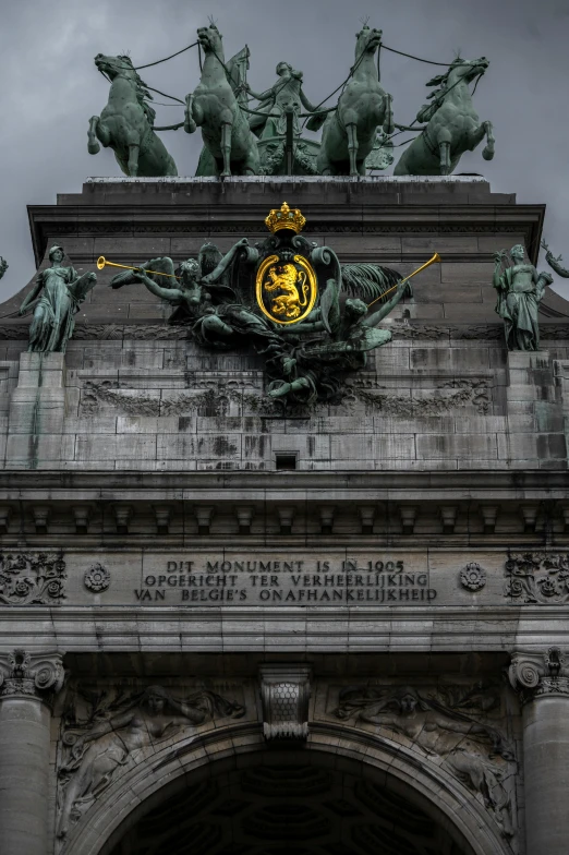 the statue above the entrance of an old building