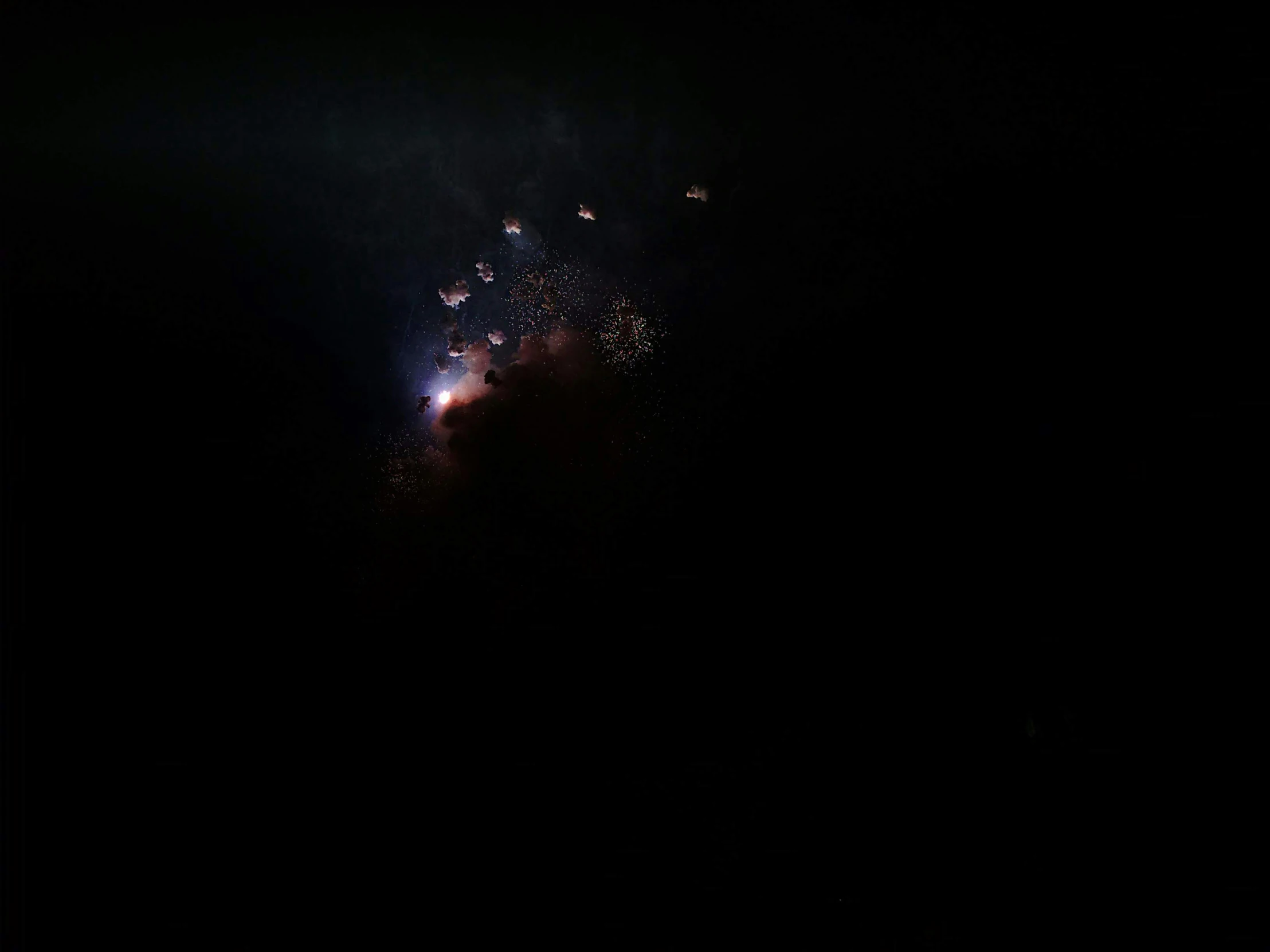 an image of fireworks exploding in the dark night sky
