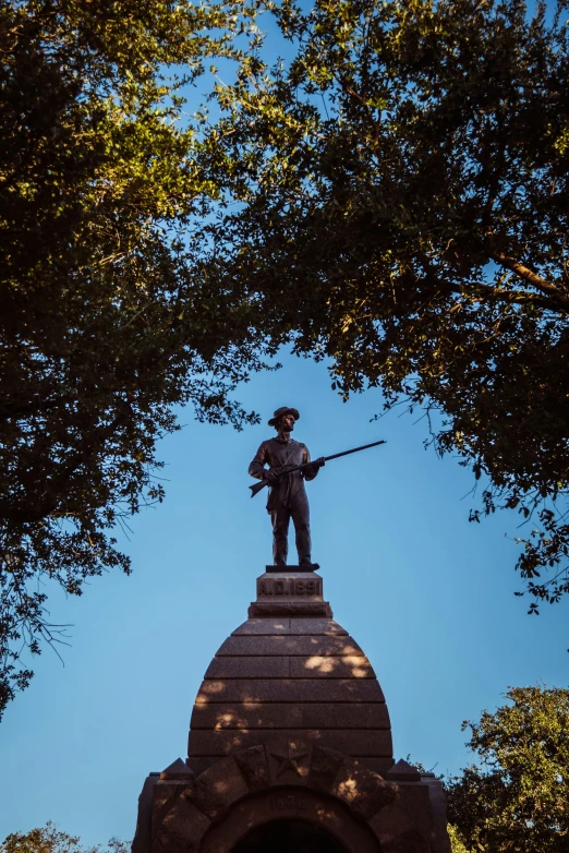 a statue that has a man holding a gun