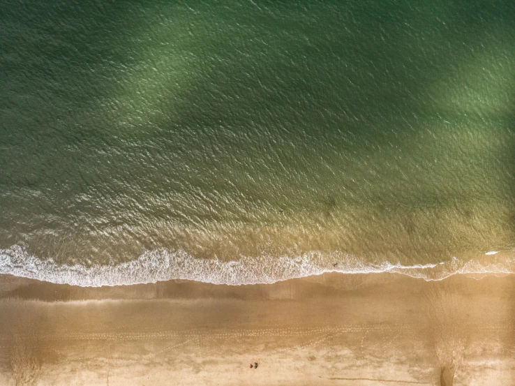 an aerial s of the beach near an ocean