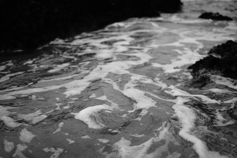 the water is rushing past the rocks