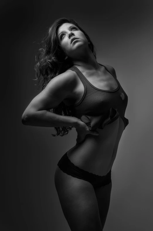 a beautiful woman wearing lingerie posing in a black and white po
