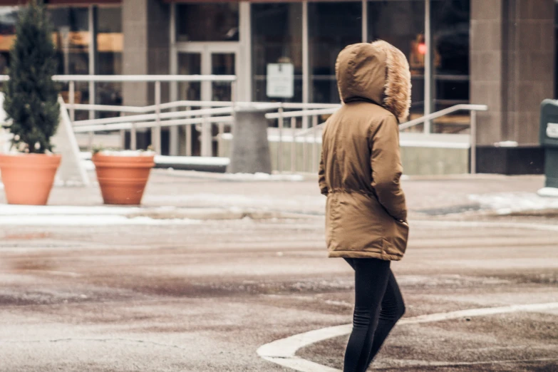 a person walking down a city street in the rain