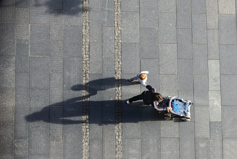 an overhead view of a man with a large umbrella