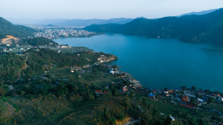 an aerial view of a town and body of water